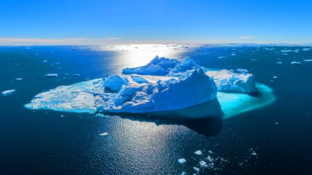 Towering over the Eiffel Tower, the world's largest iceberg breaks free and roams the seas